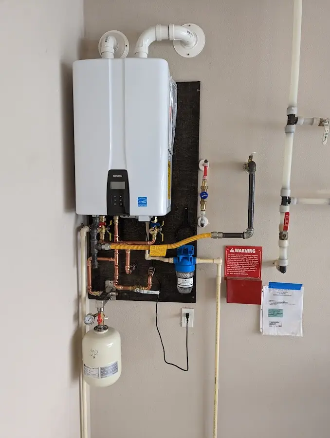 Professional plumber installing copper piping in a Vassalboro home